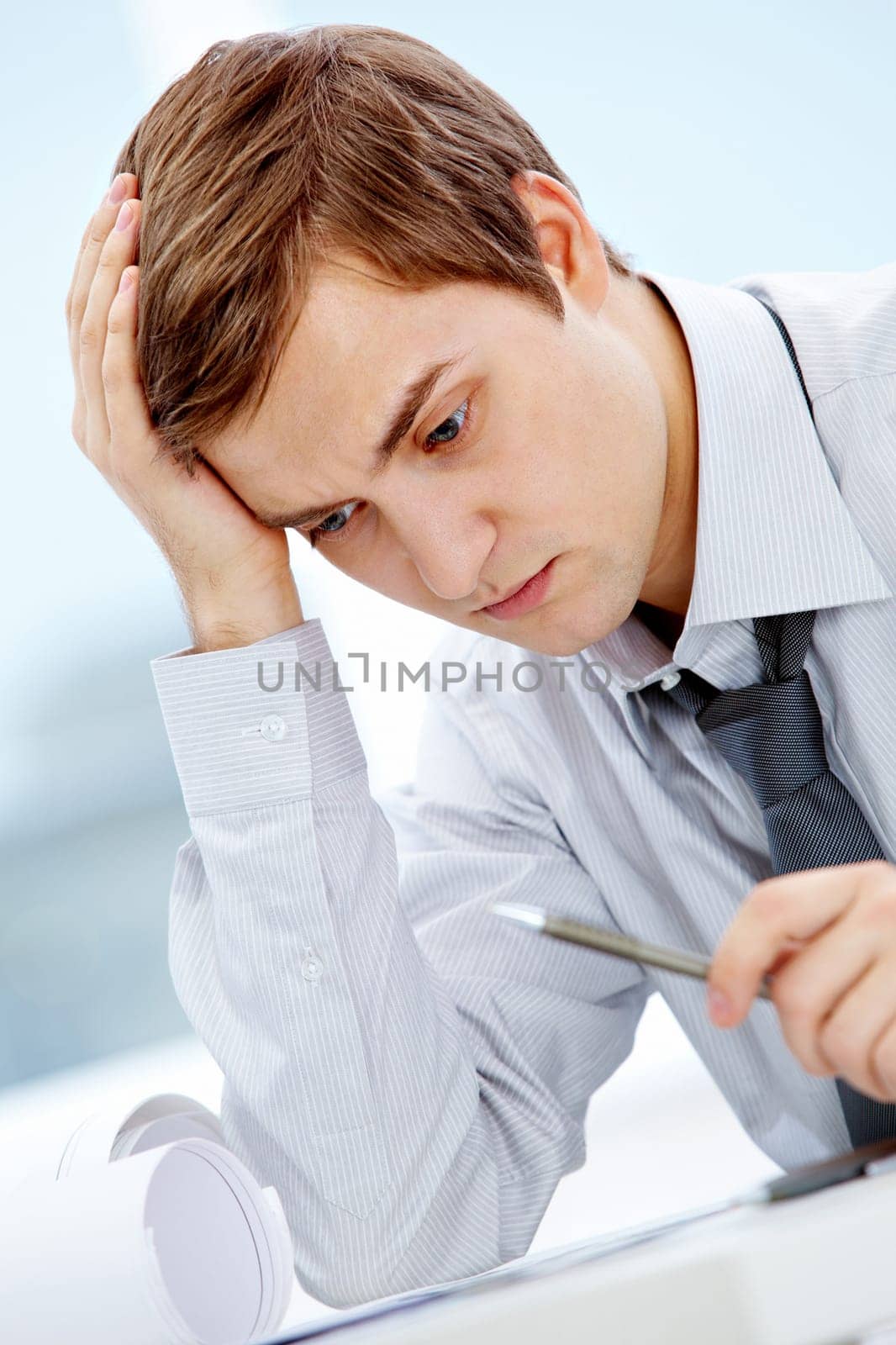 Portrait of thinking businessman touching his head