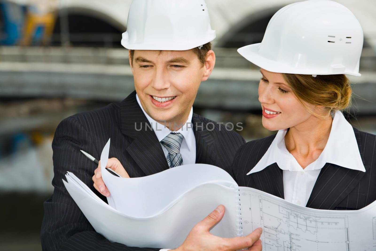Confident female worker is showing a architectural plan to her chief