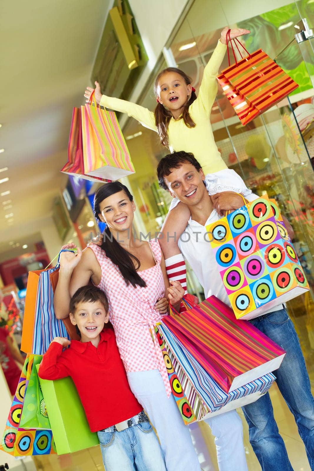 Parents with two children shopping in trade center