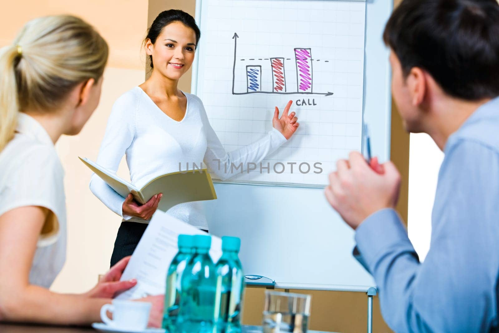 Portrait of confident woman demonstrating her project pointing to the whiteboard