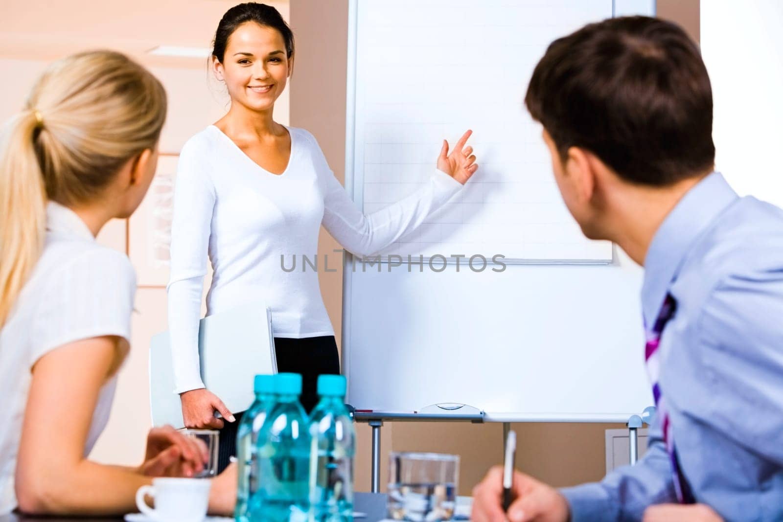 Portrait of business woman demonstrating  something on the whiteboard at seminar