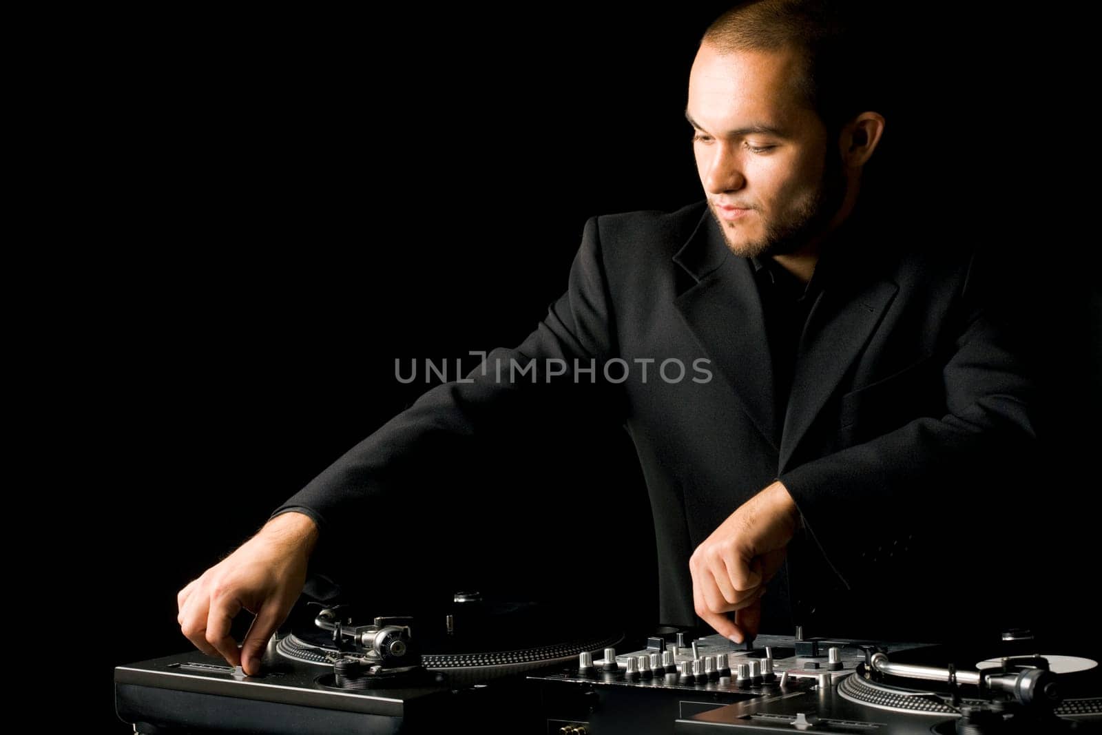 Portrait of handsome deejay playing club music