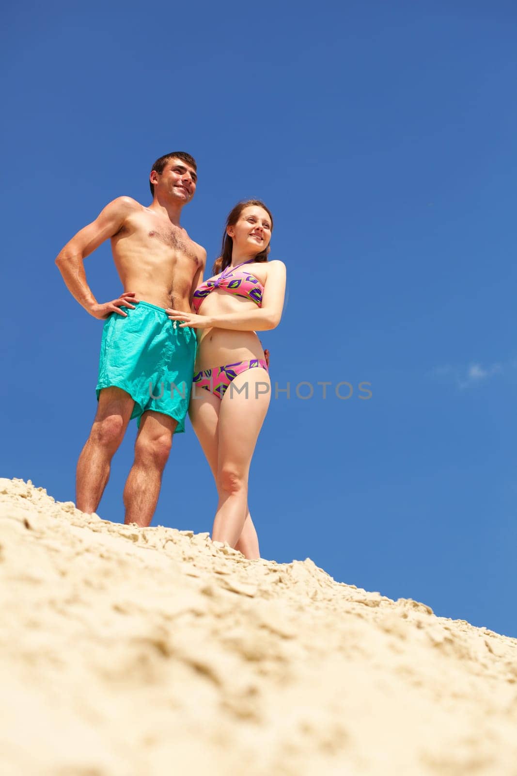 Peaceful couple enjoying summer vacation on sandy beach