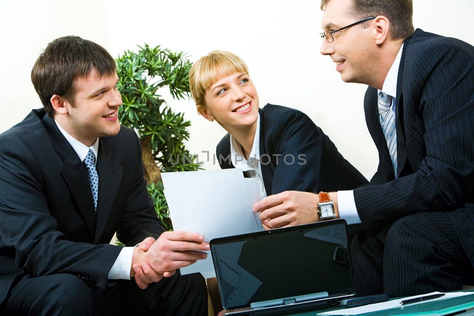 Business man passing the documents to his partner at meeting