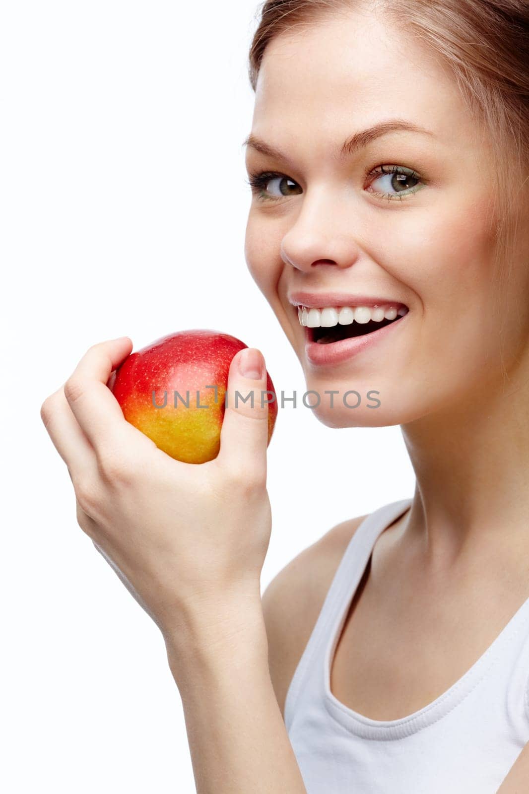 Portrait of a young girl biting an apple