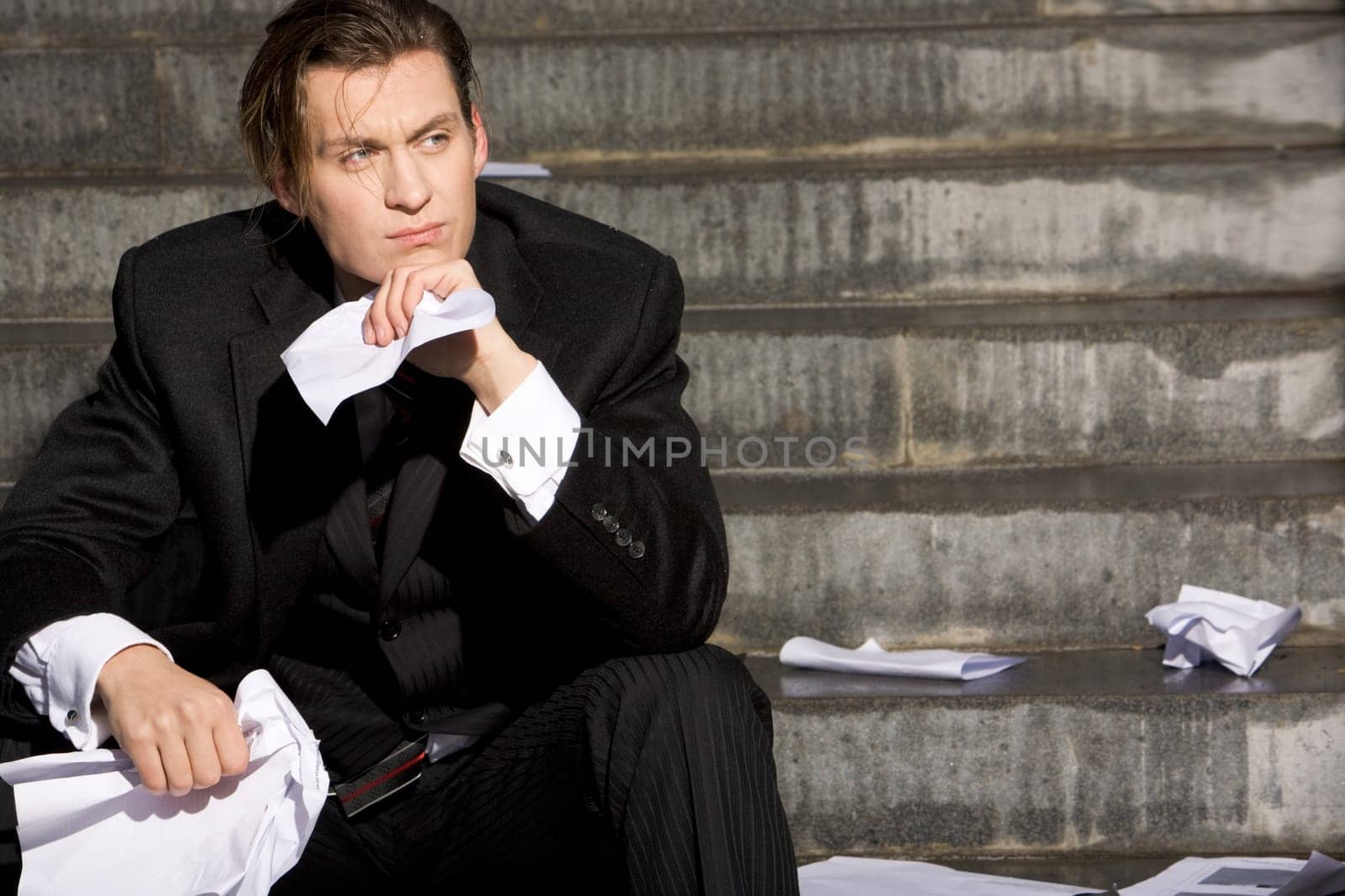 Portrait of thoughtful business man touching his chin and looking aside