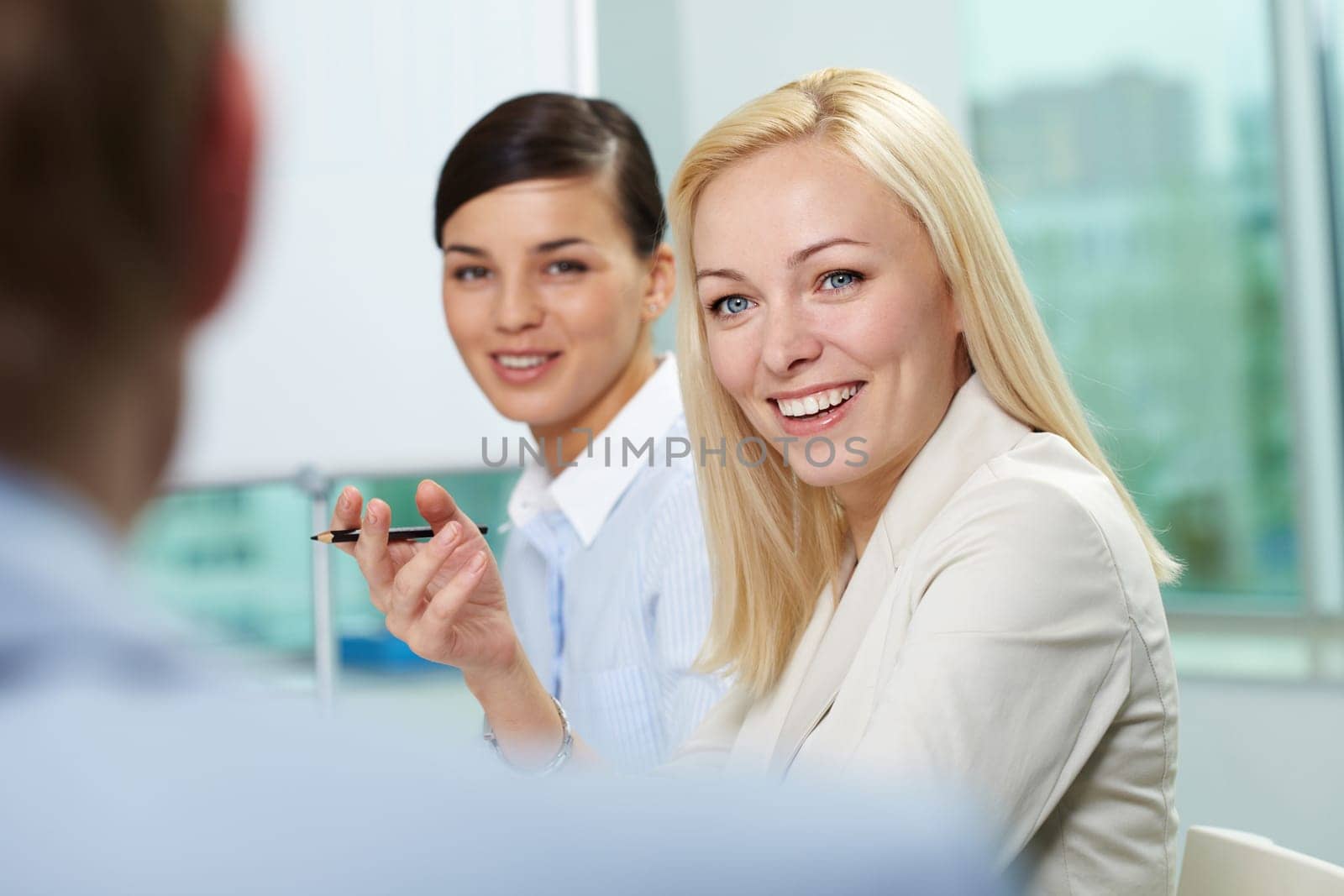 Young businesswoman addressing her colleague