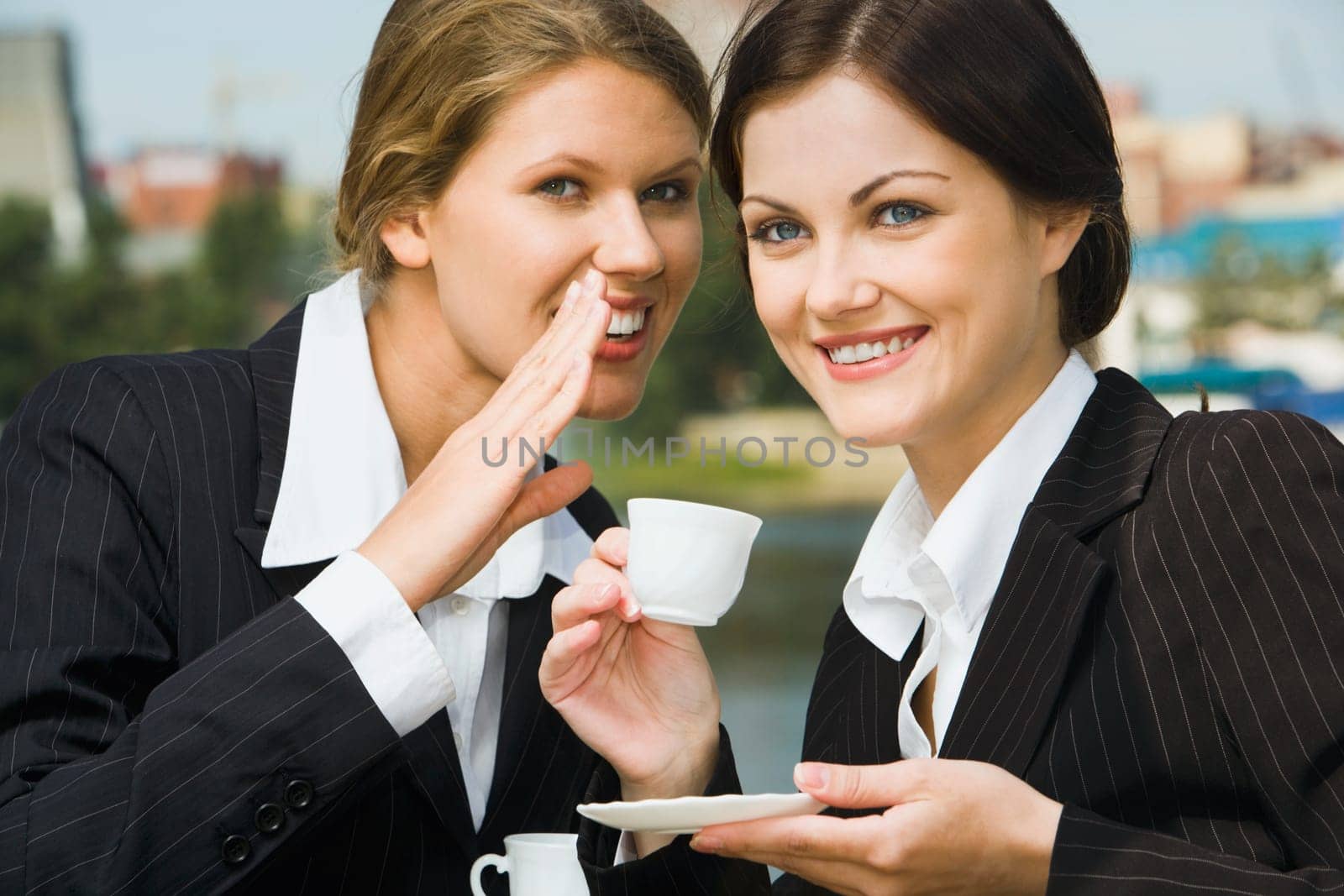 Confident  business woman is talking to her colleague
