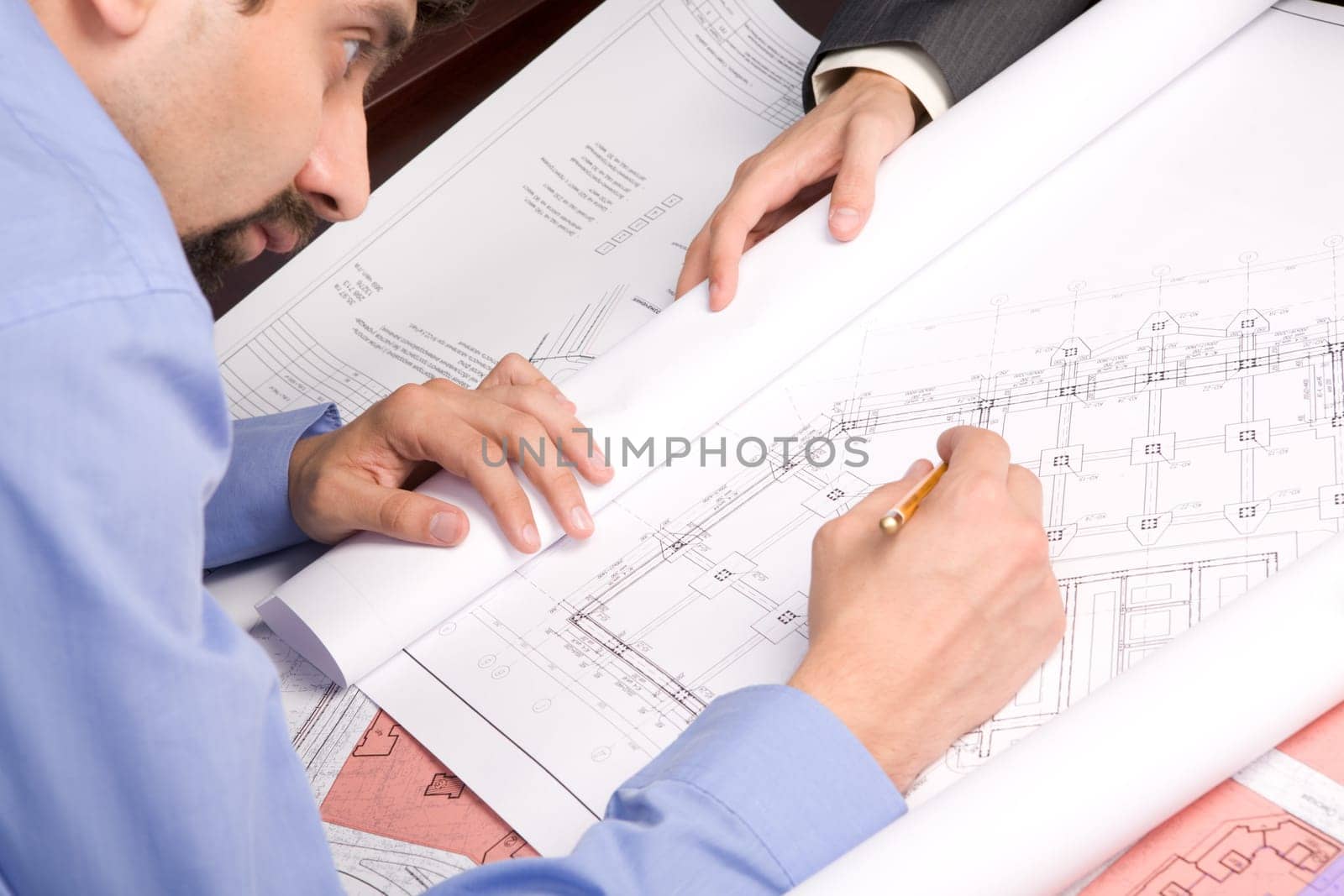 Above view of engineer over blueprint while working at new draft