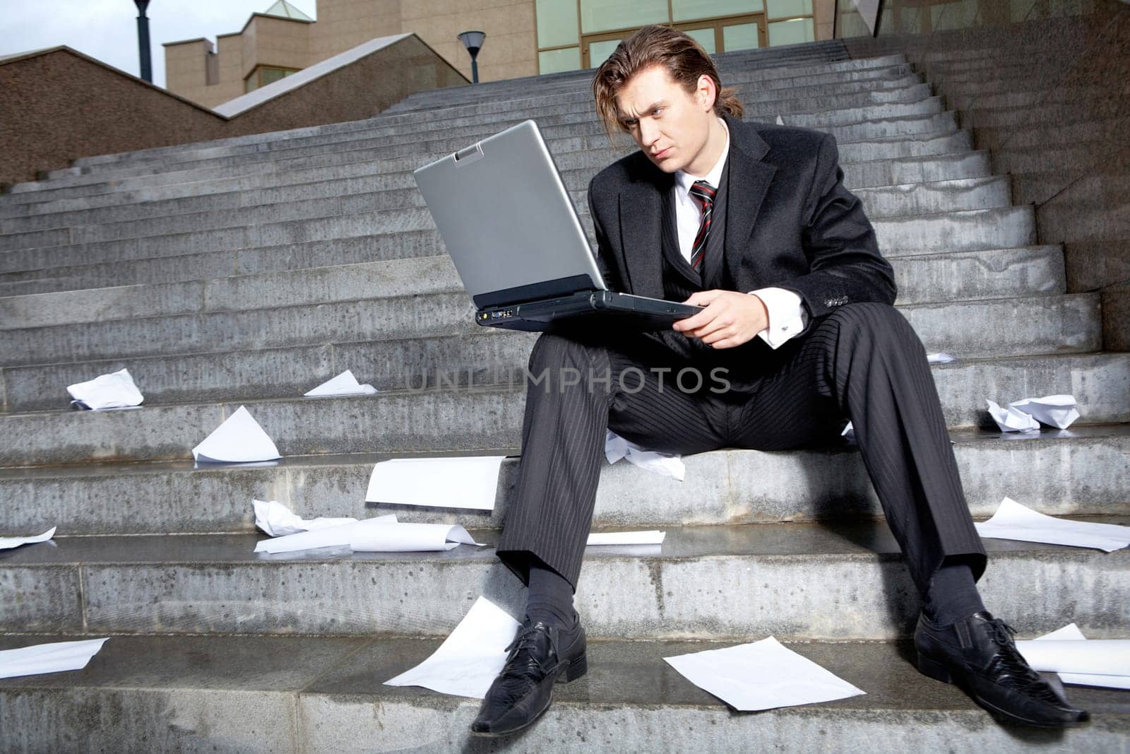 Portrait of serious business leader with laptop looking at its monitor
