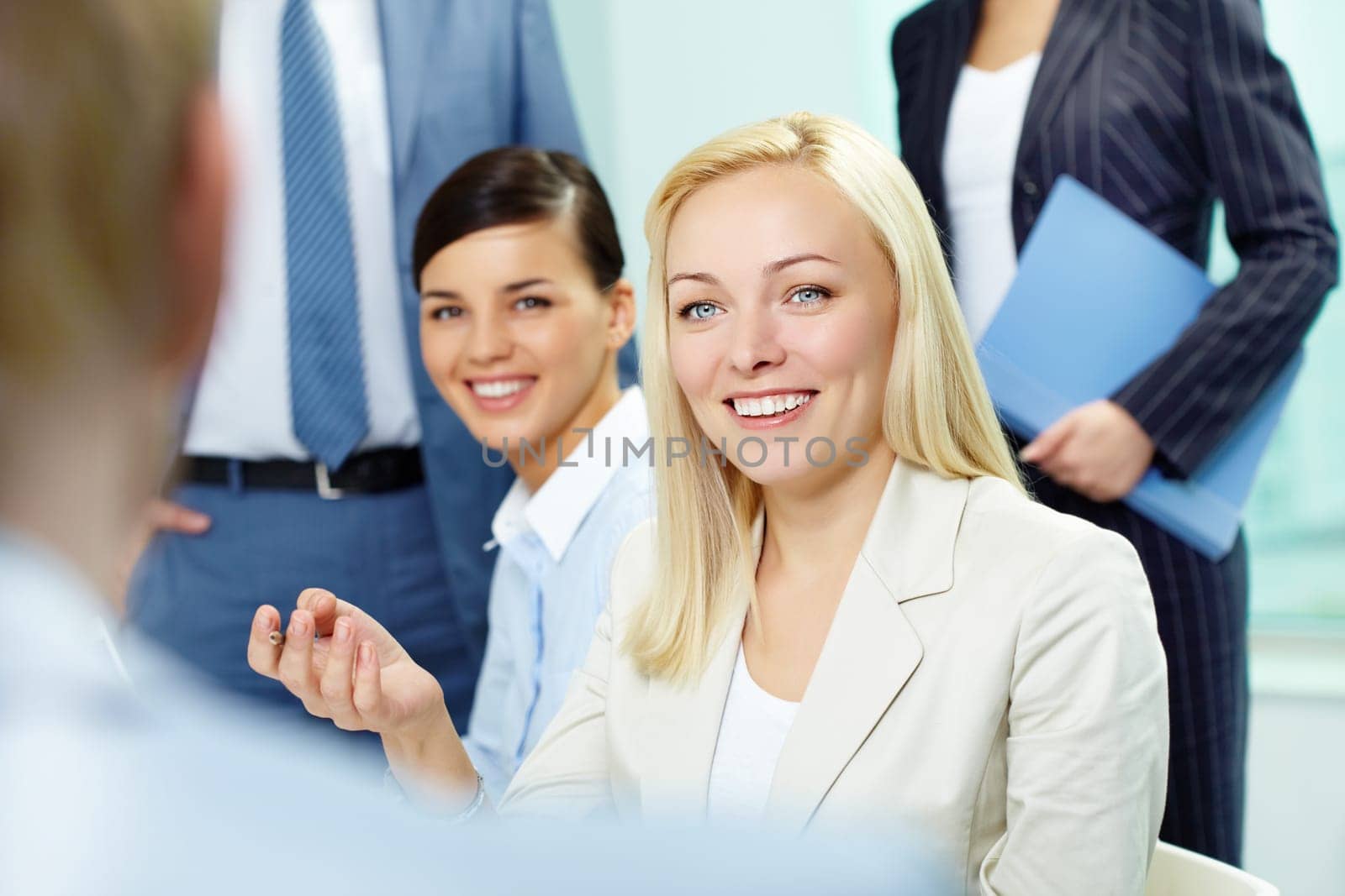 A woman manager looking at business partner during conversation