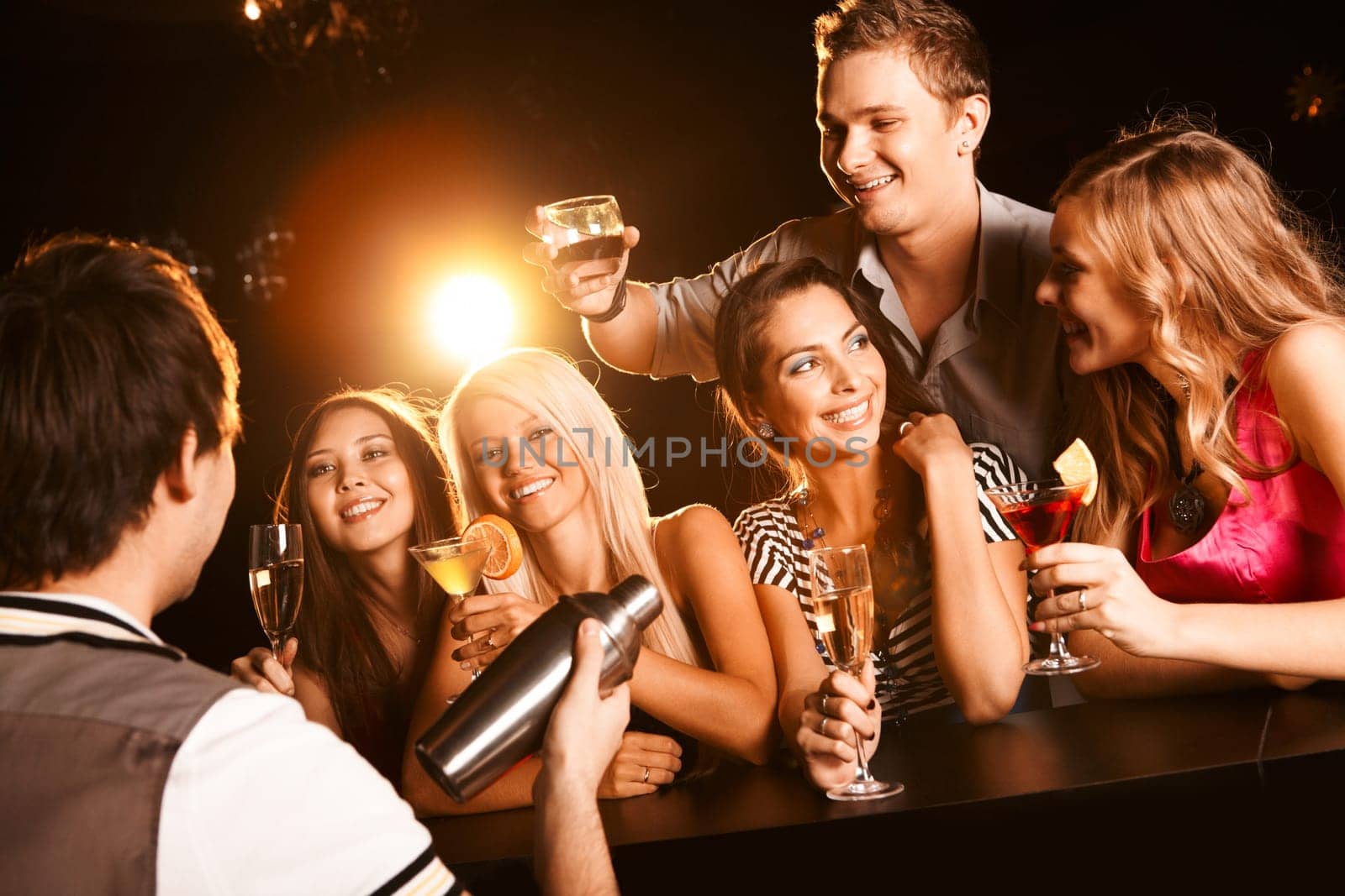 Photo of joyful friends in the bar communicating with each other