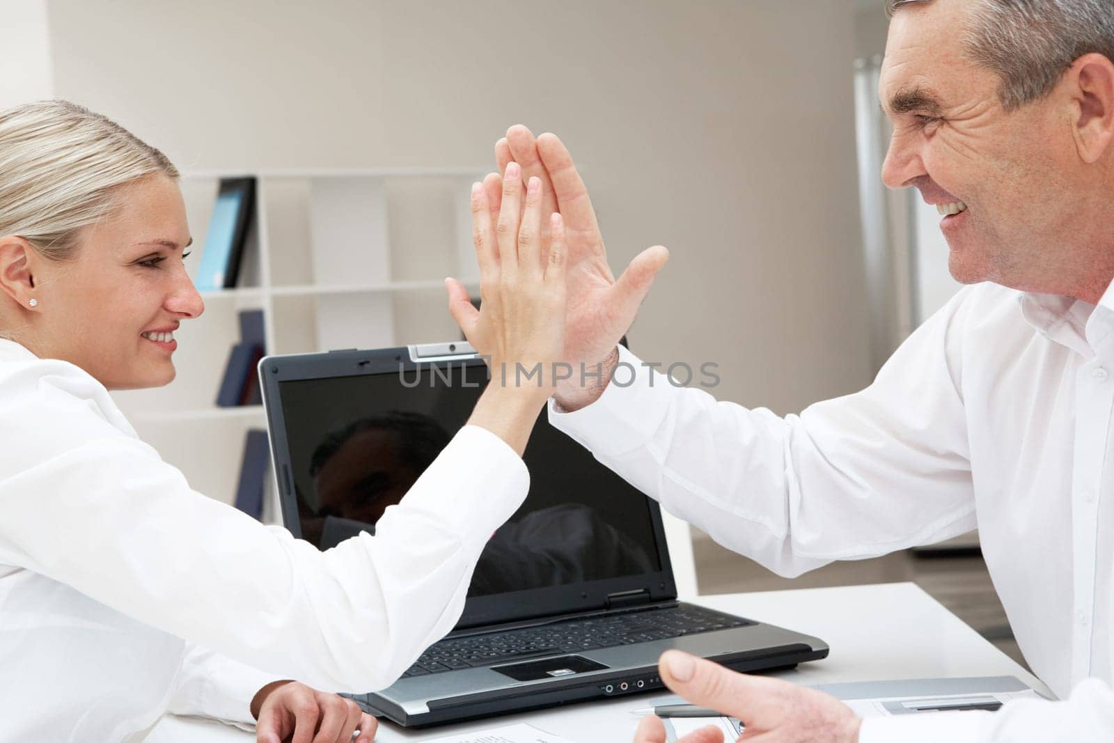 Image of business partners with their palms opposite each other symbolizing support