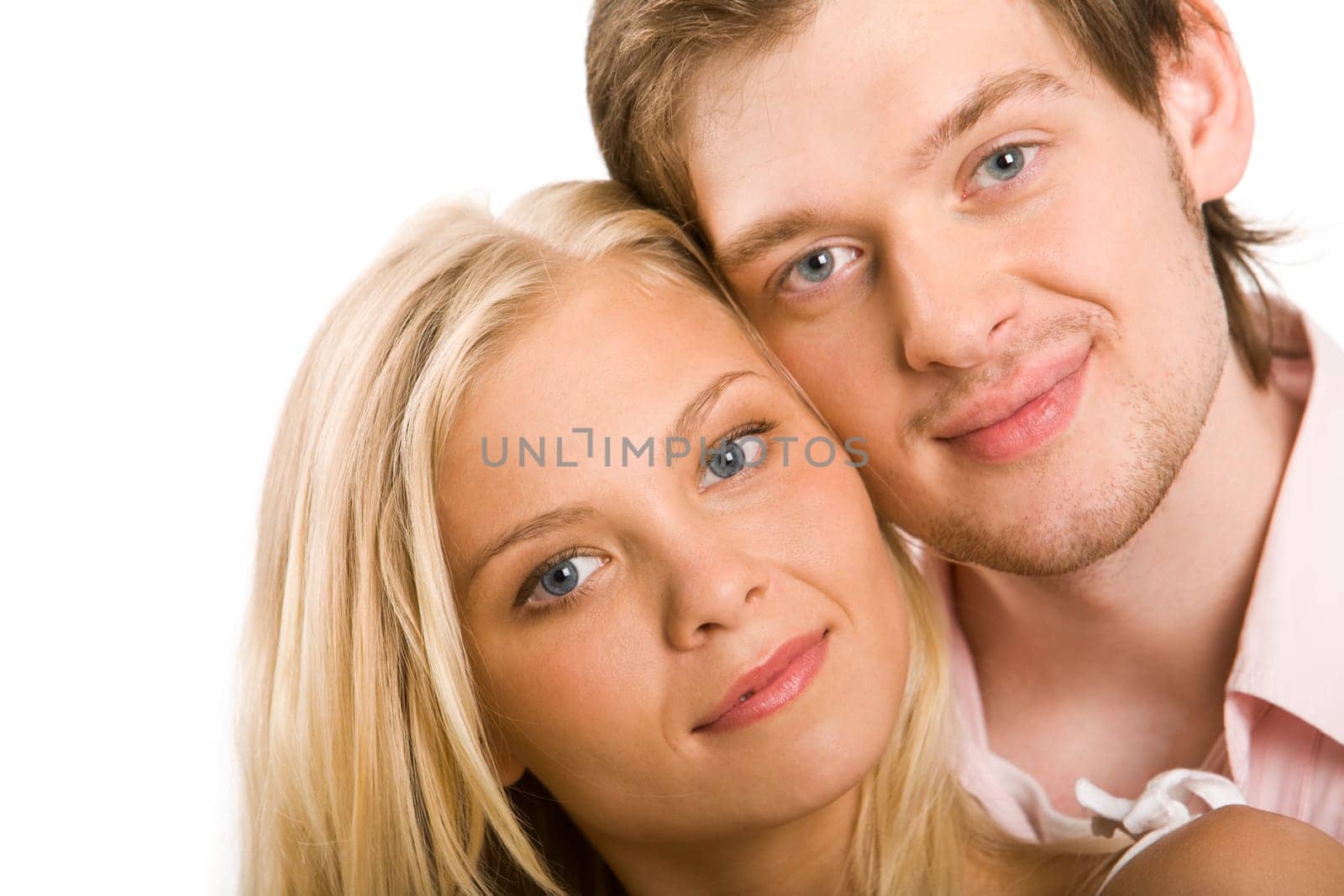 Handsome guy looking at camera with lovely girlfriend by his side