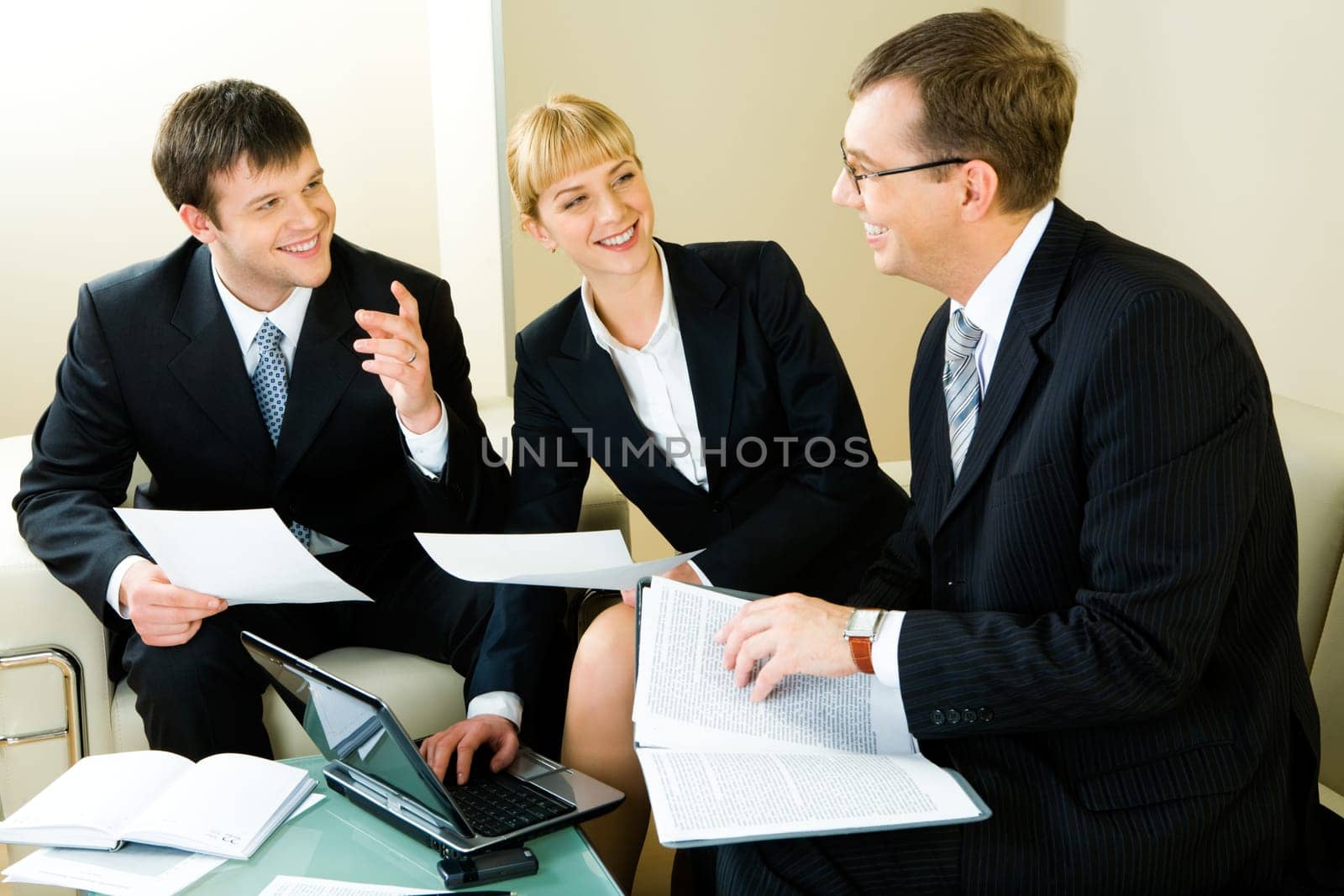 Image of three confident entrepreneurs discussing a new business decision