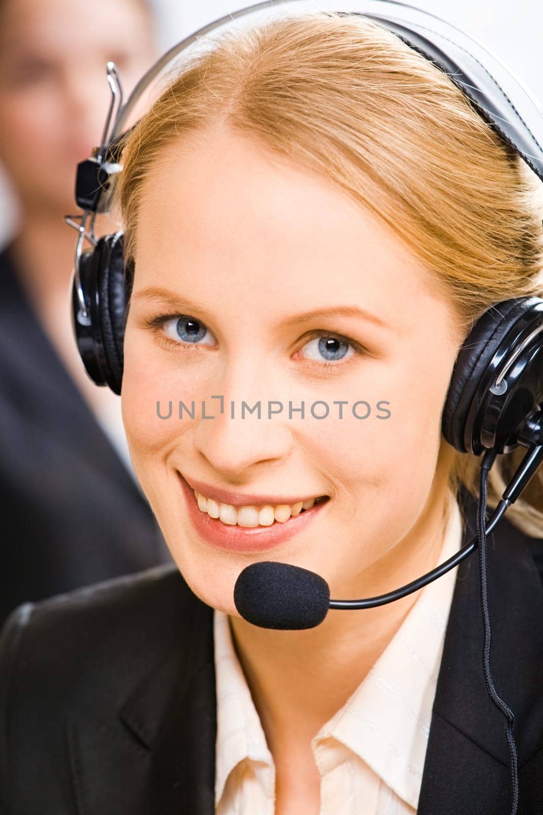 Face of young smiling confident consultant with blue eyes