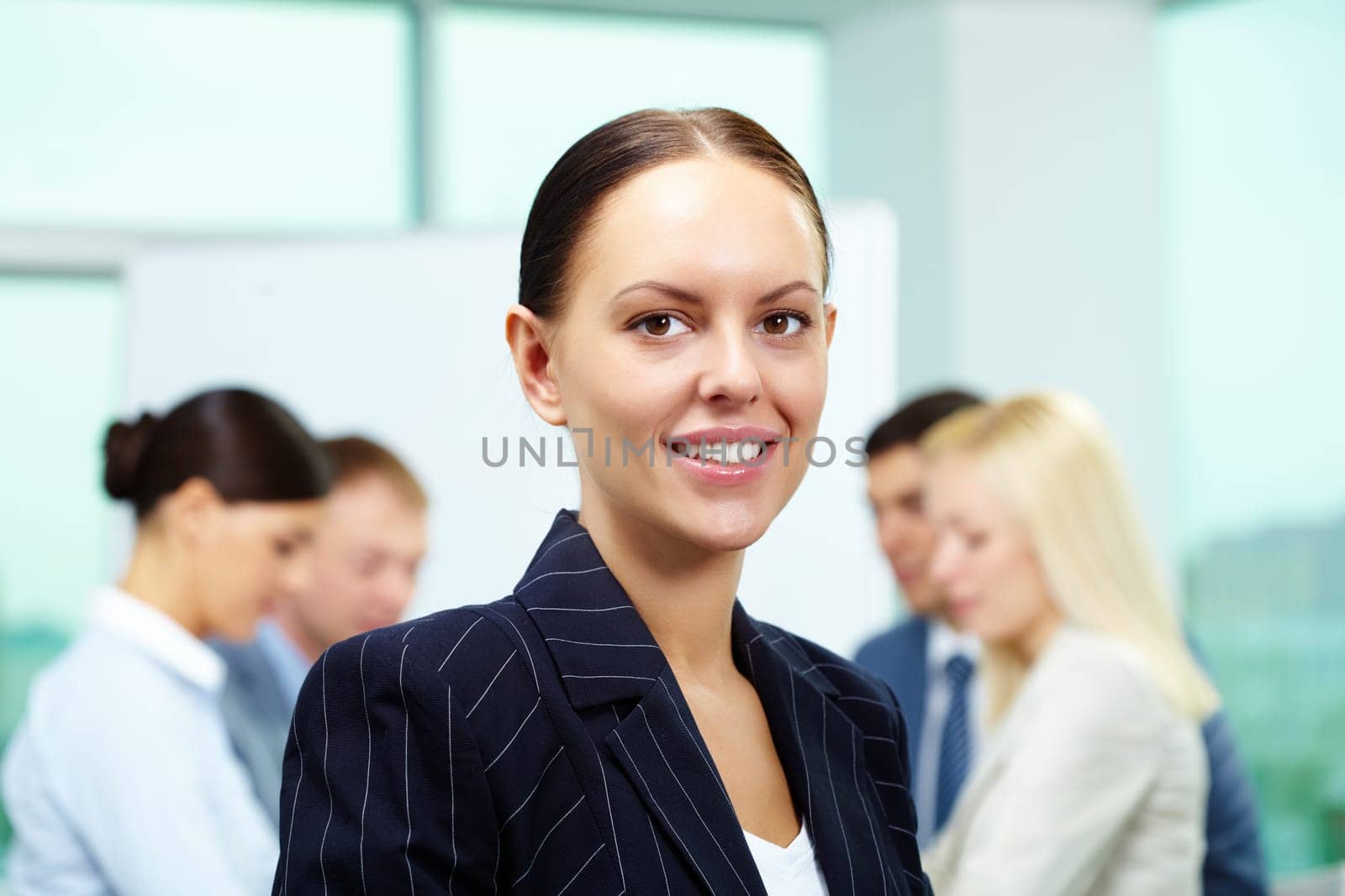 Portrait of smart employer looking at camera in working environment