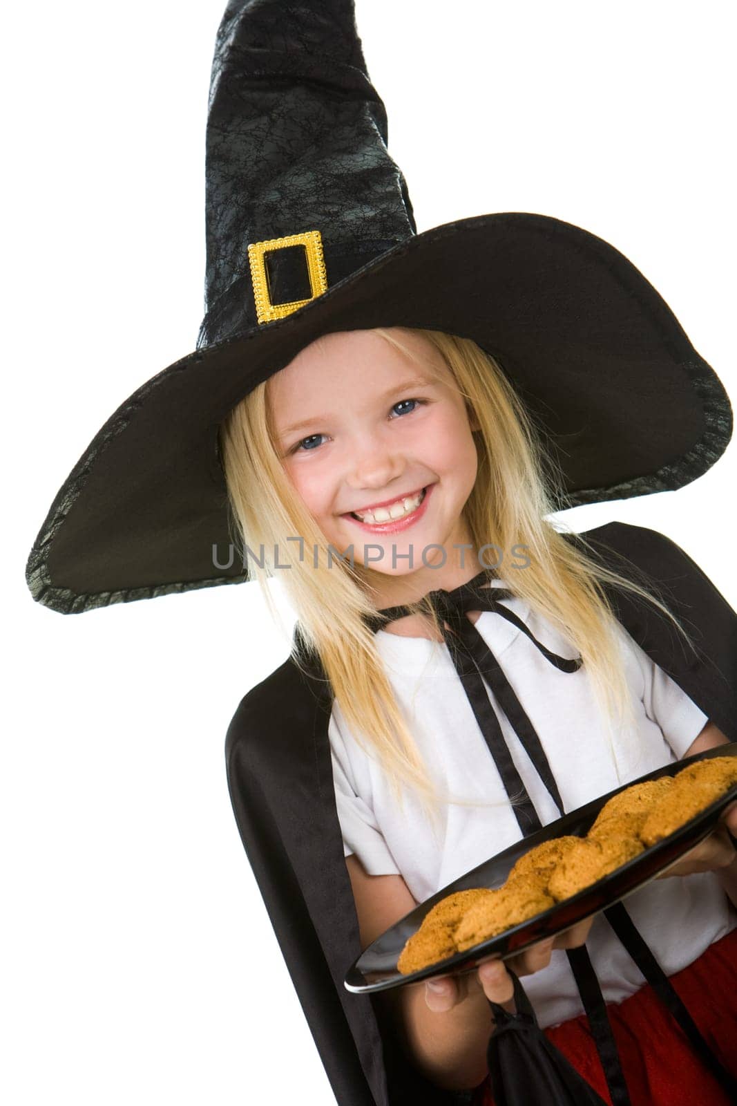 Photo of girl in halloween costume holding tray with bisquits