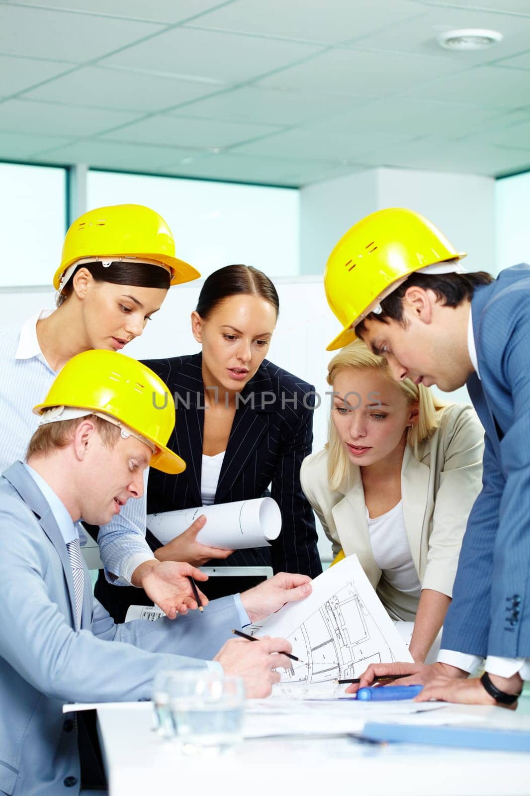 Group of architects looking at a project and discussing it