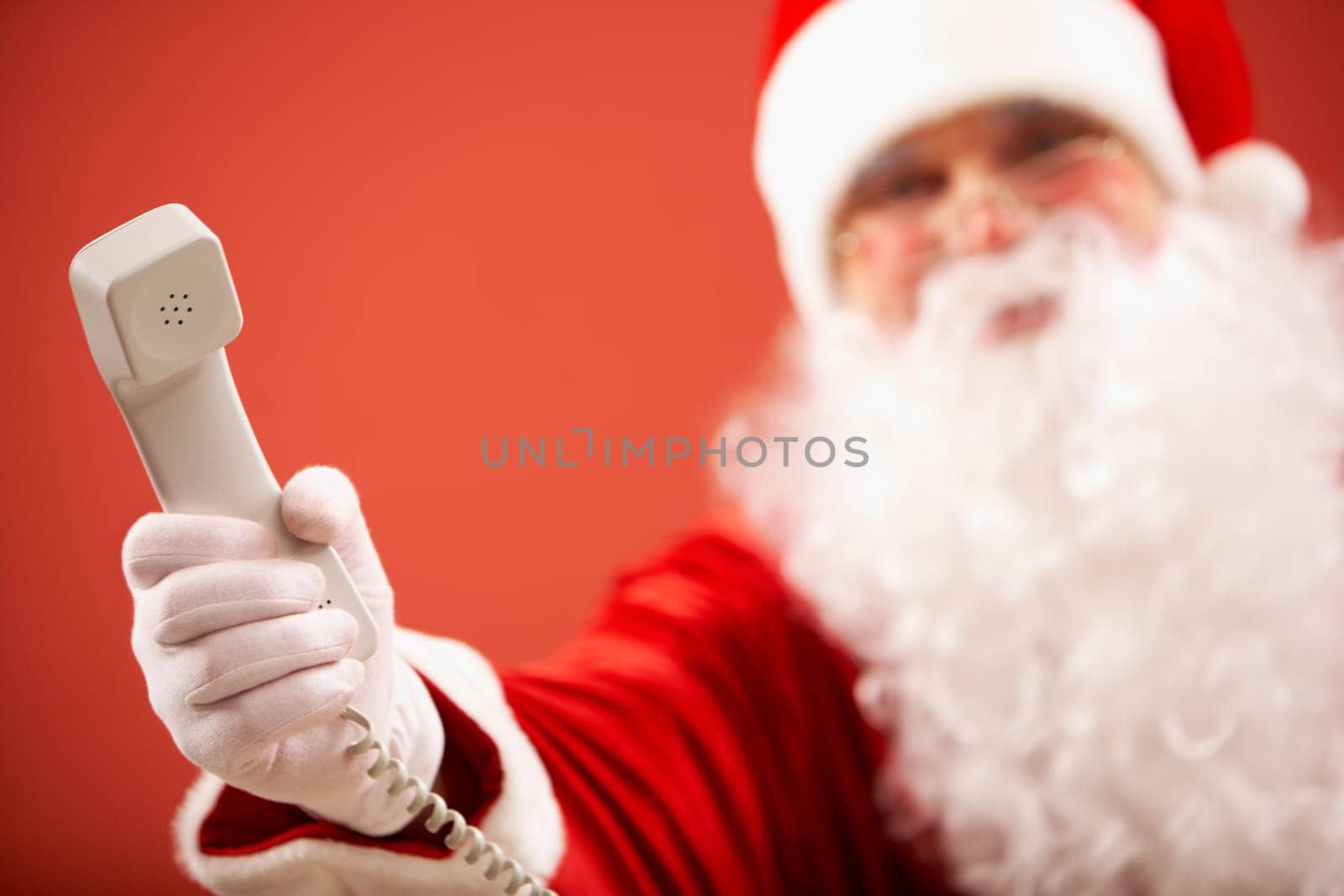 Photo of Santa Claus giving phone receiver to you