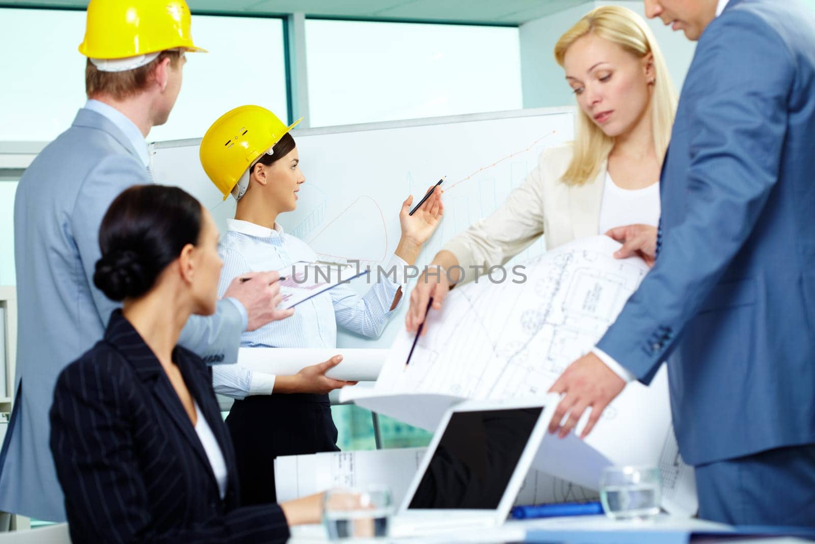 Group of architects interacting in office at meeting
