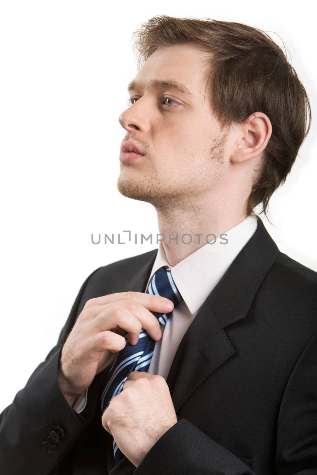 Photo of elegant man getting dressed isolated over white background