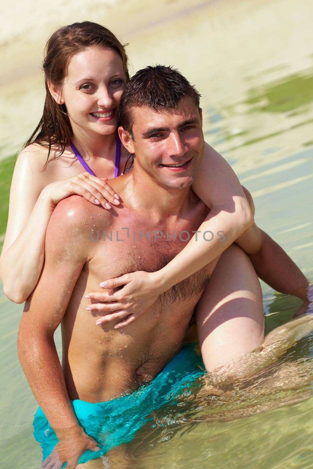 Portrait of happy couple on summer vacation looking at camera
