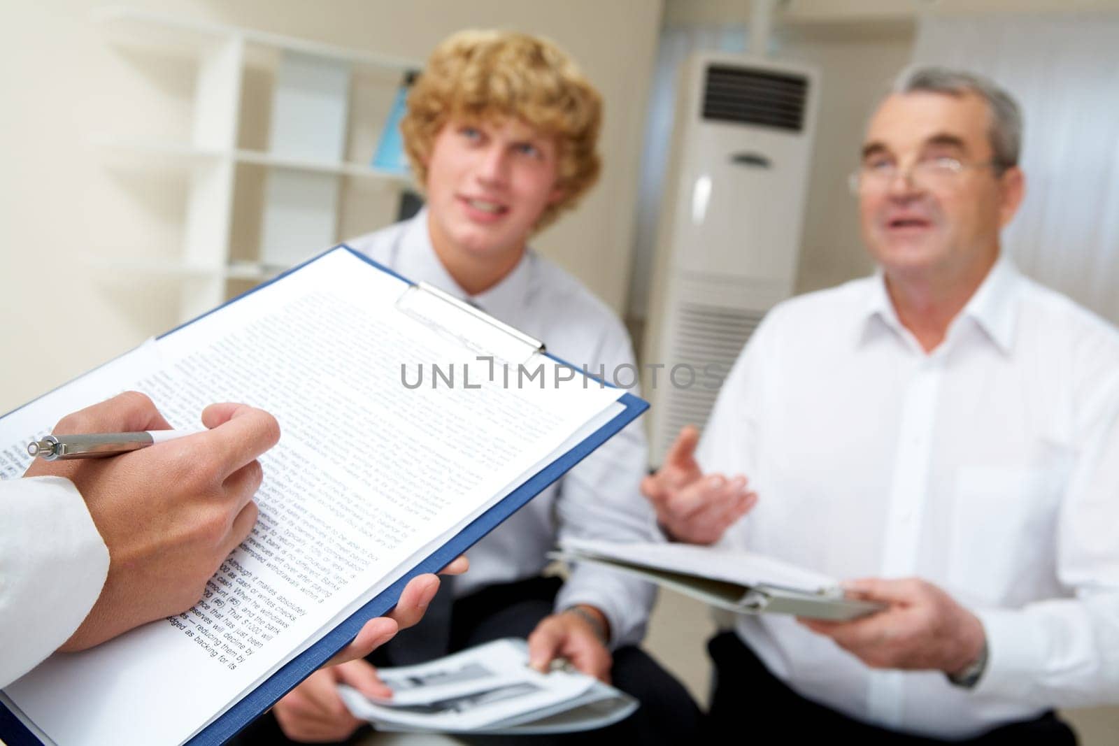Image of secretary hand with pen over document at business seminar