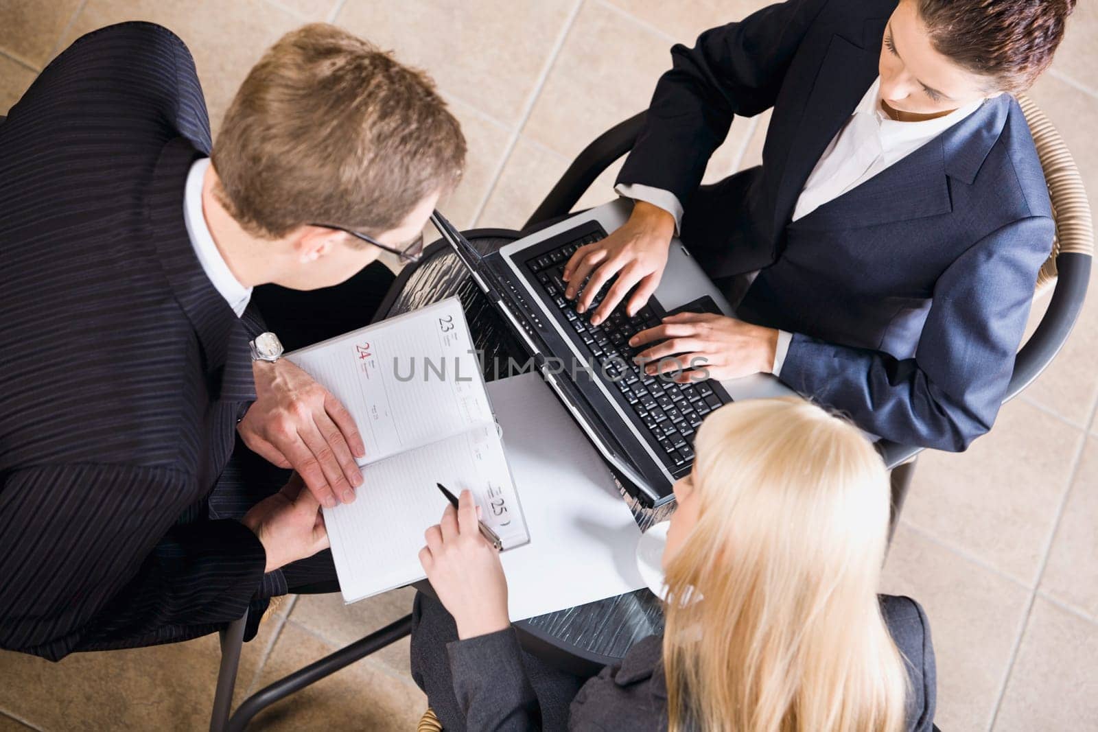 Businesspeople gathered around a table for a meeting and brainstorming