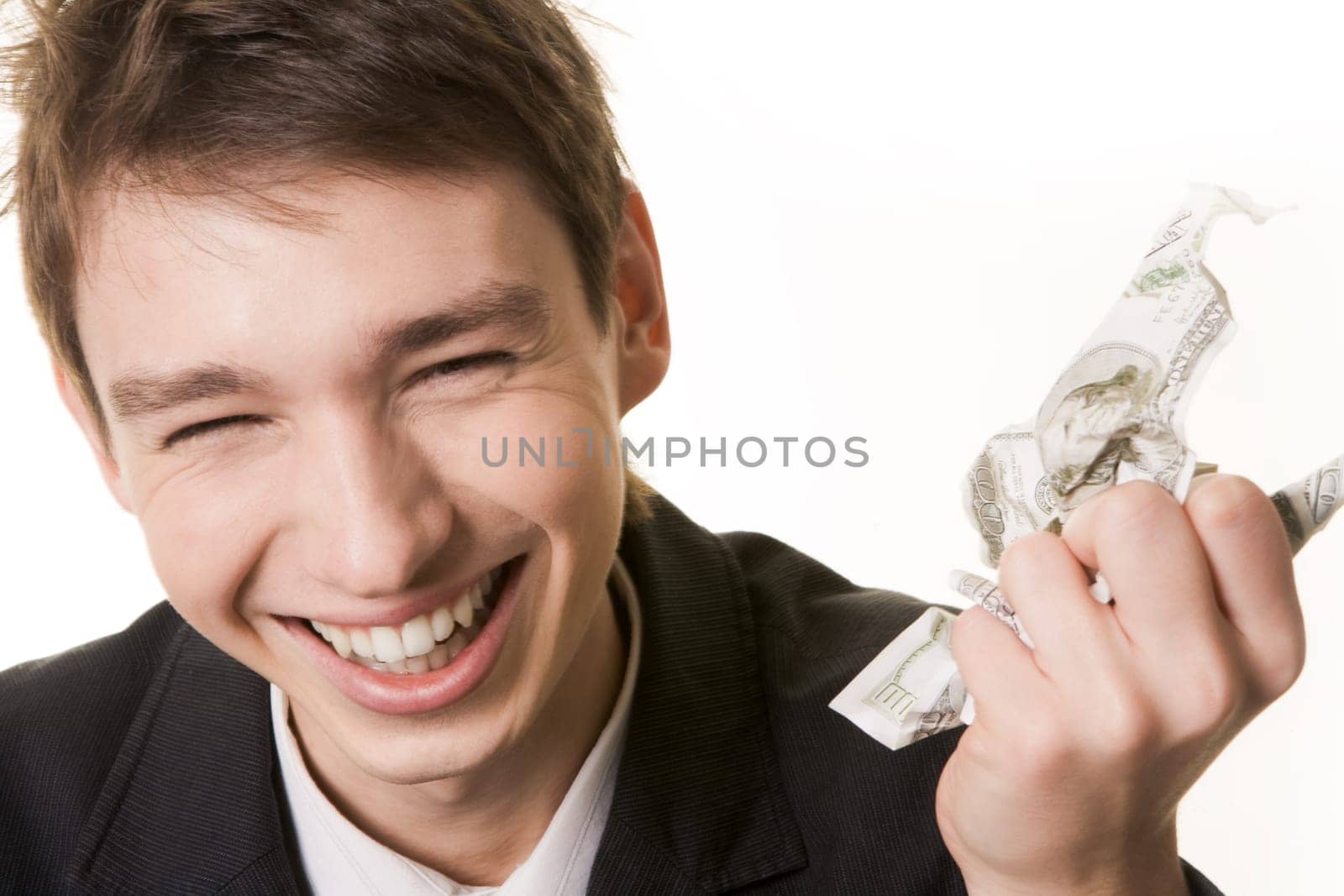 Photo of laughing male with crumpled dollar banknote in hand over white background