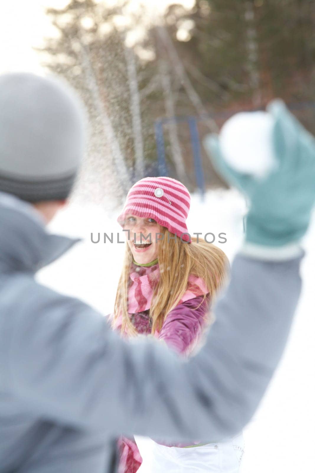 Image of attractive young woman flinging the snowball and having fun