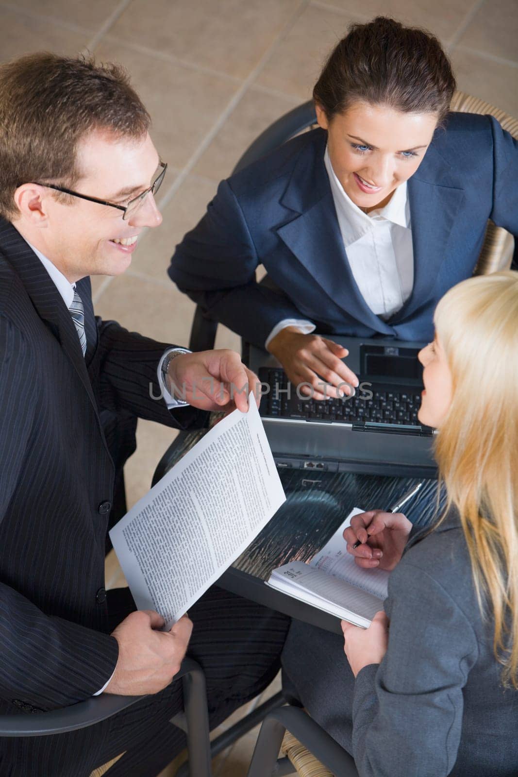 Portrait of three businesspeople discussing a new important project