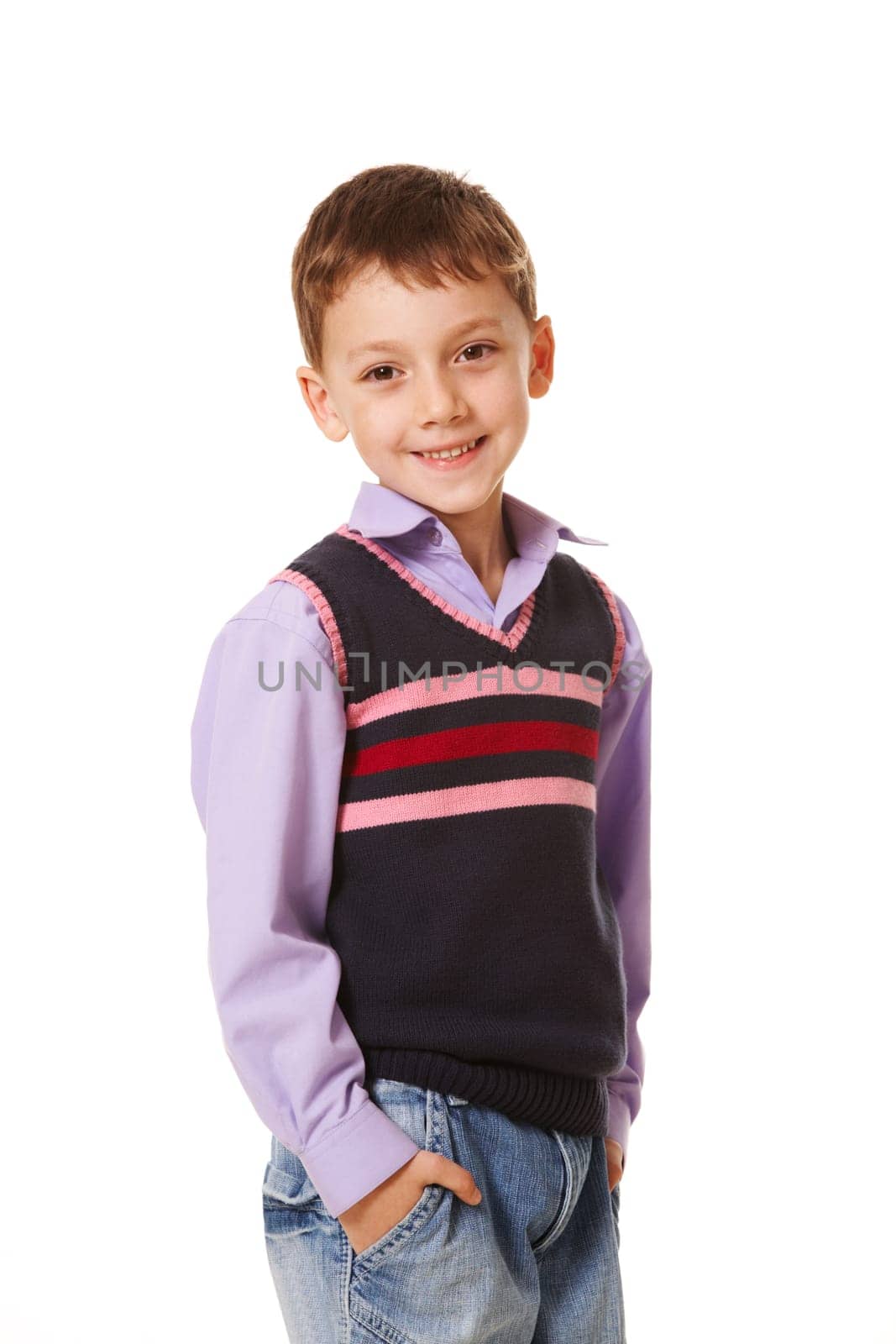 Portrait of smiling boy looking at camera on a white background
