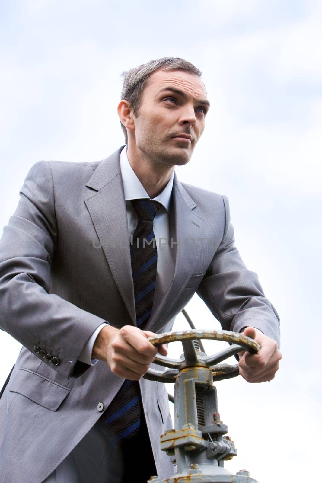 Portrait of strong leader steering on background of sky