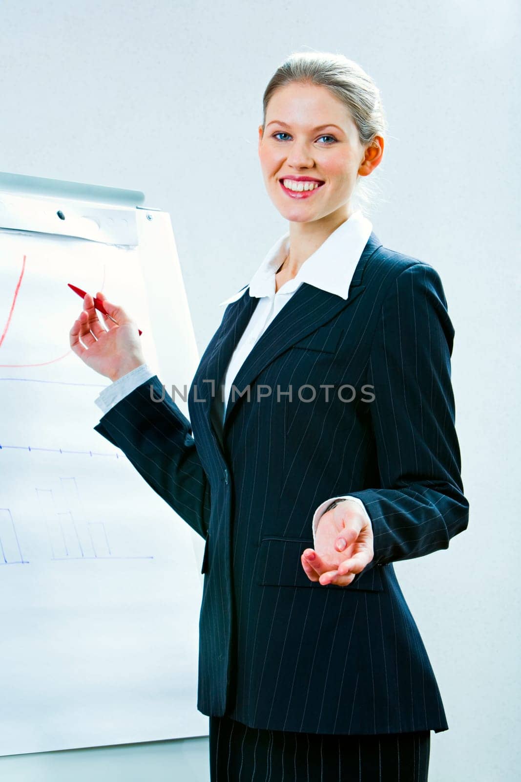 Portrait of confident teacher explaining a new lecture standing with whiteboard near by