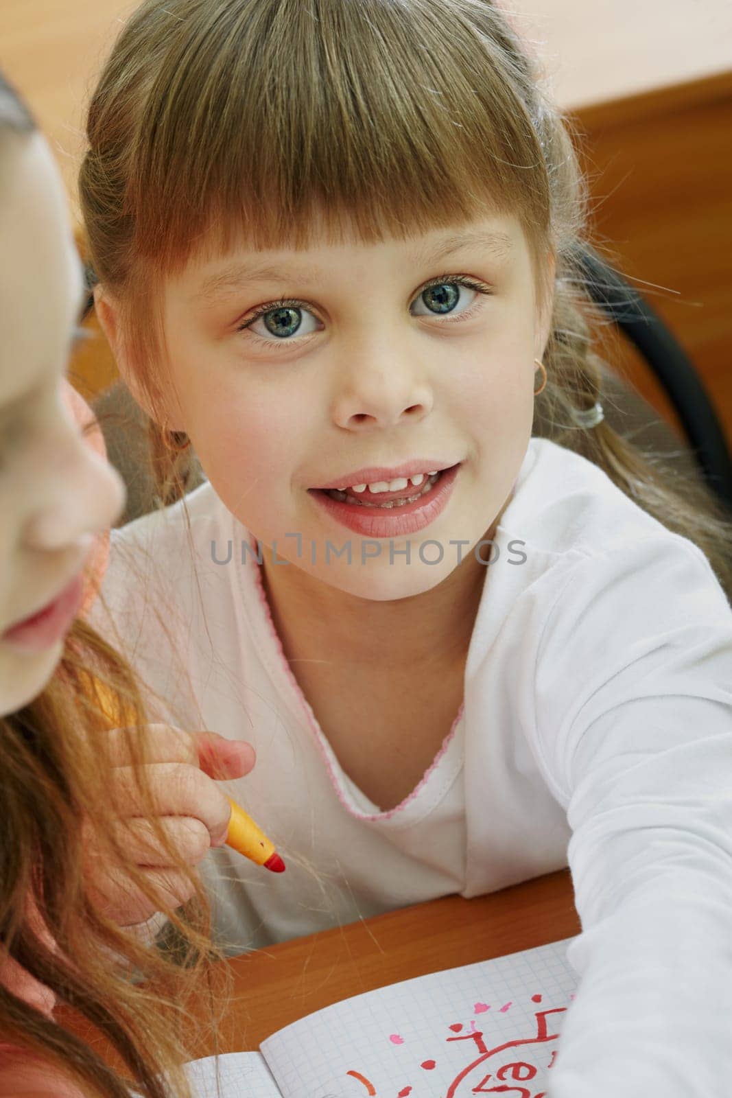 Portrait of smart schoolgirl looking at camera at drawing lesson