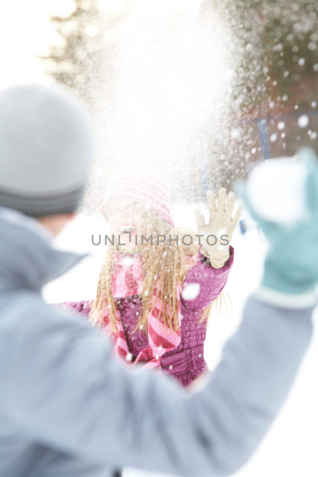 Image of attractive young woman flinging the snowball and having fun
