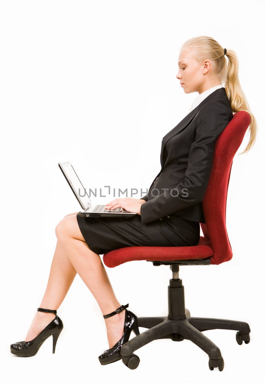 Profile of serious businesswoman sitting on arm-chair and networking