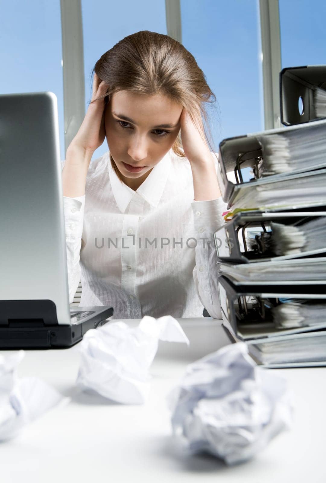 Image of tired businesswoman sitting at her workplace after hard working day