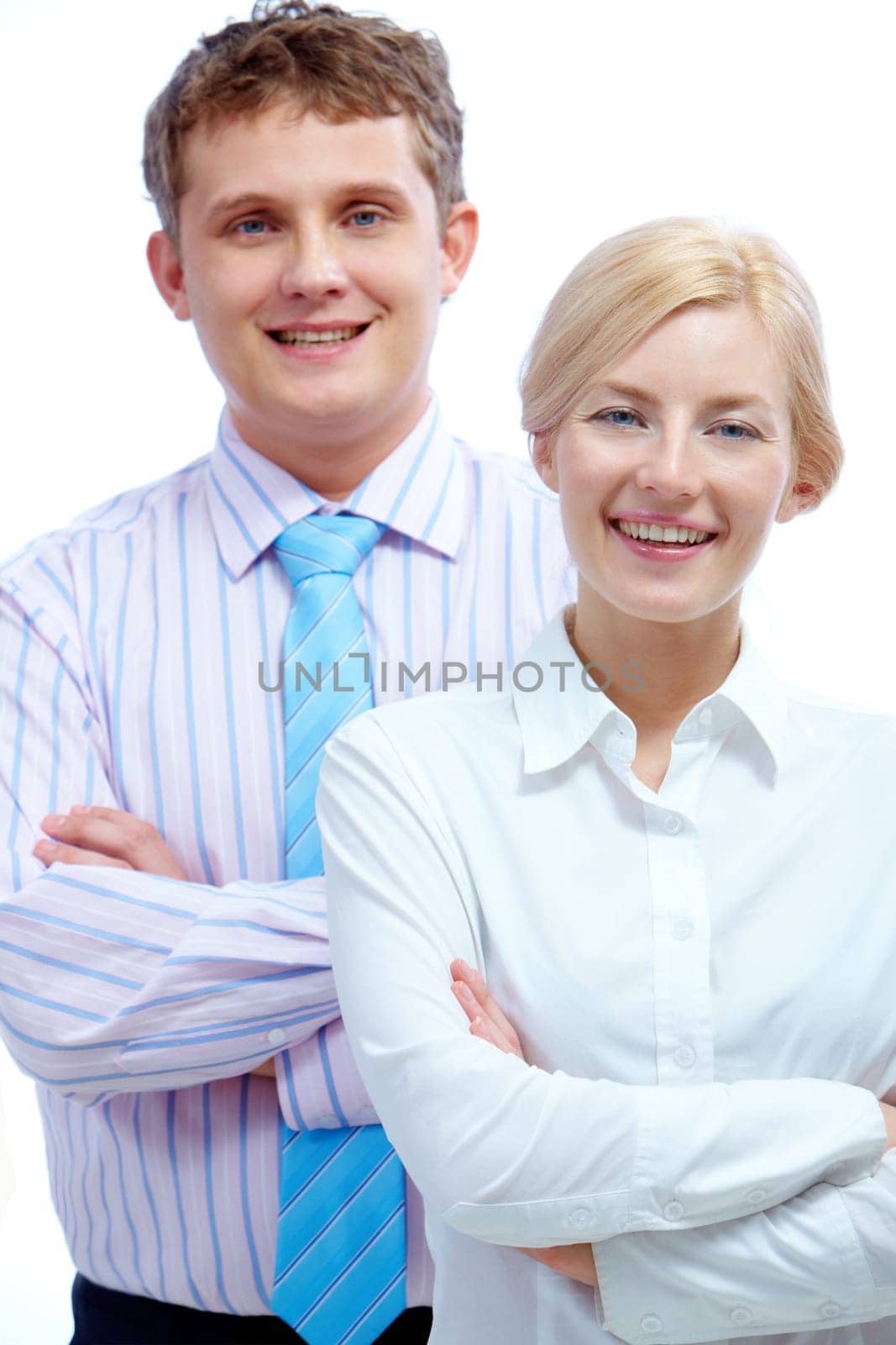 Portrait of successful businesswoman looking at camera with happy partner behind her