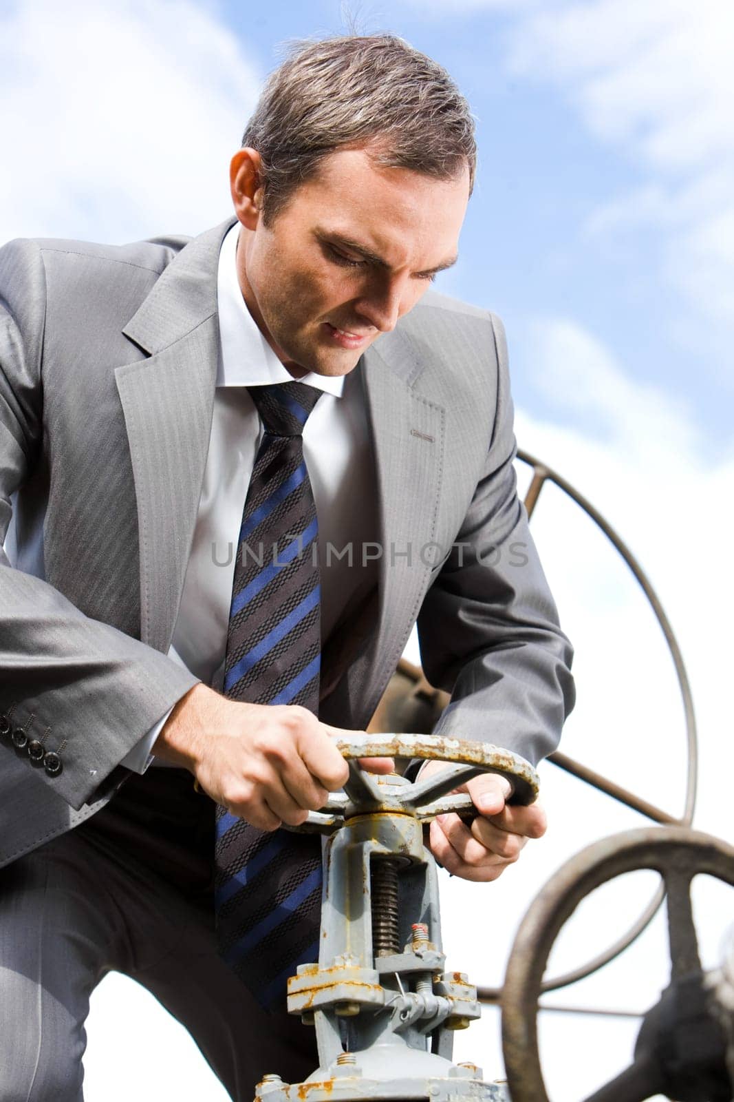 Portrait of strong leader steering on background of sky