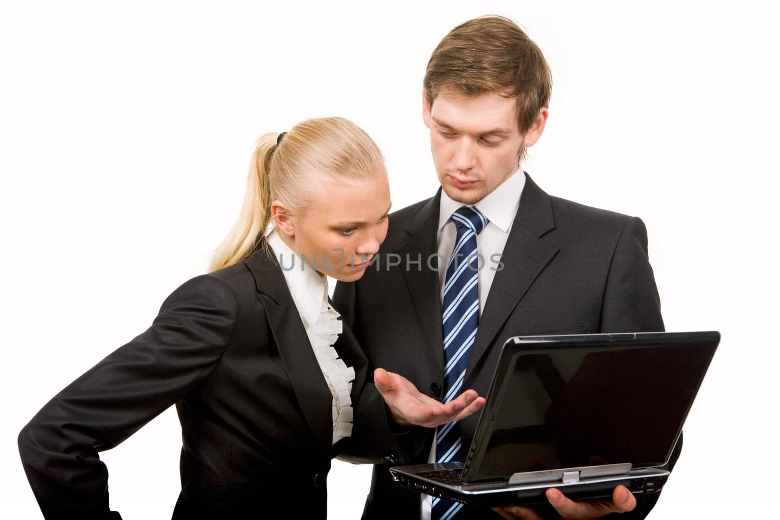 Portrait of co-workers looking at laptop screen while discussing new ideas