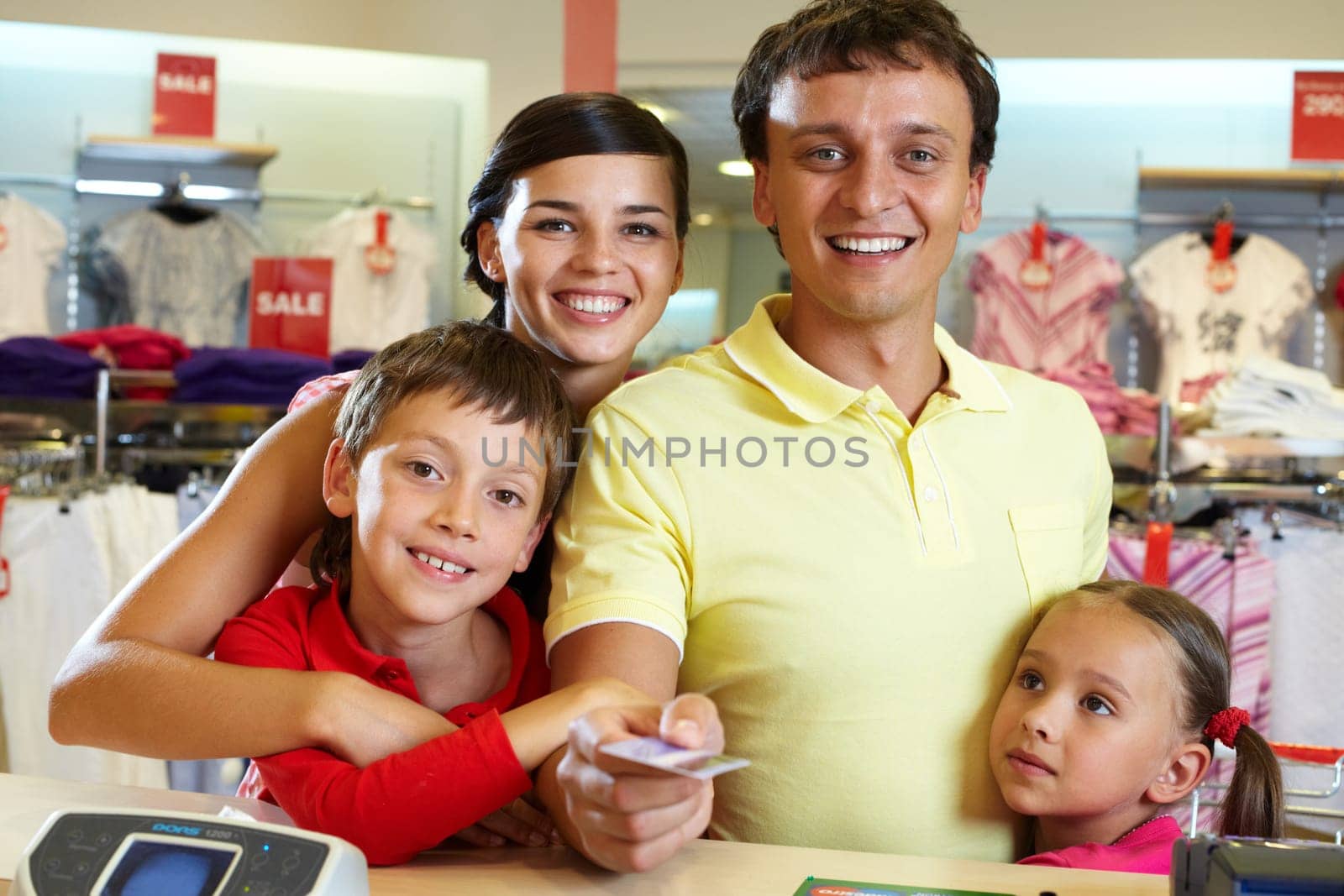 Portrait of family of four giving credit card