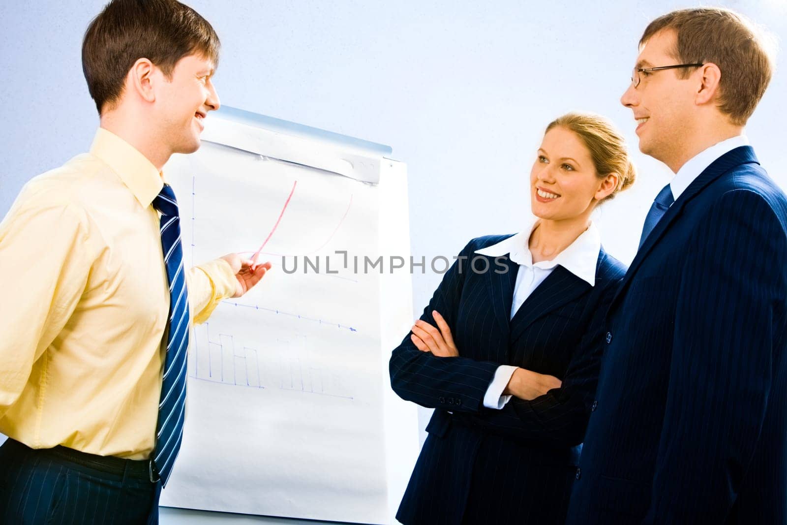 Portrait of successful businessman doing presentation on whiteboard at seminar