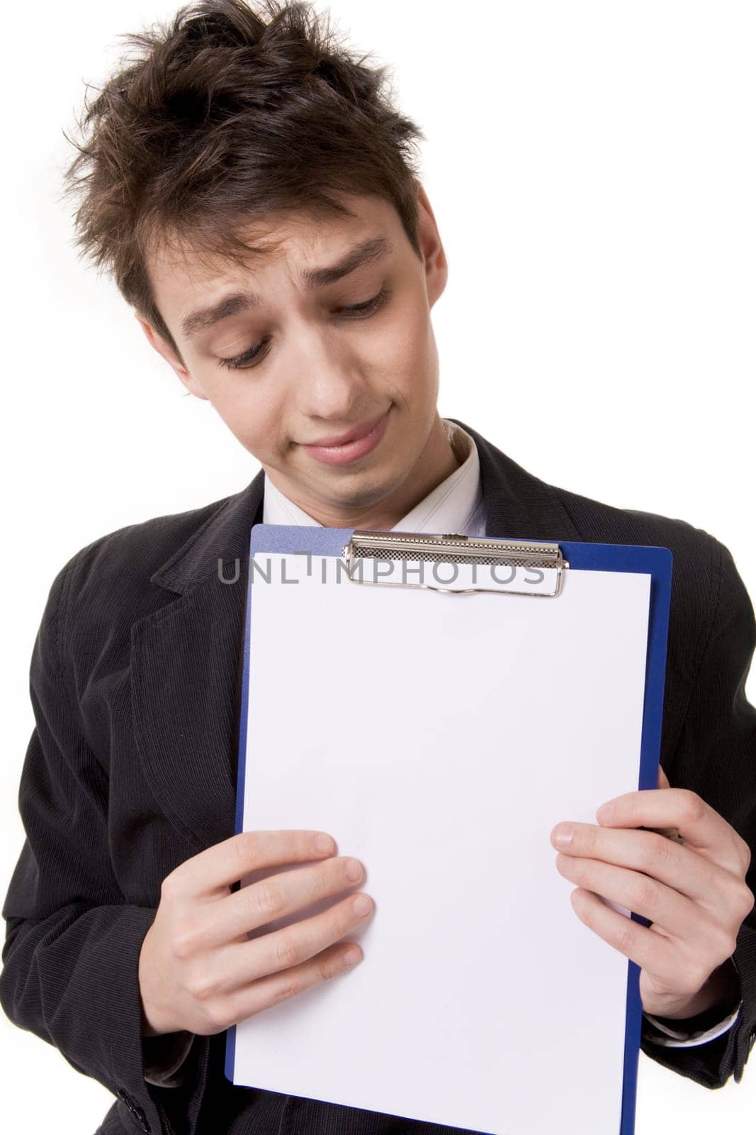 Portrait of young man with paper announcement in hands looking at it curiously