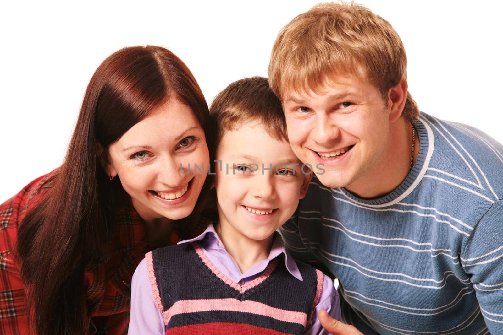 Portrait of happy parents and their preschool son looking at camera