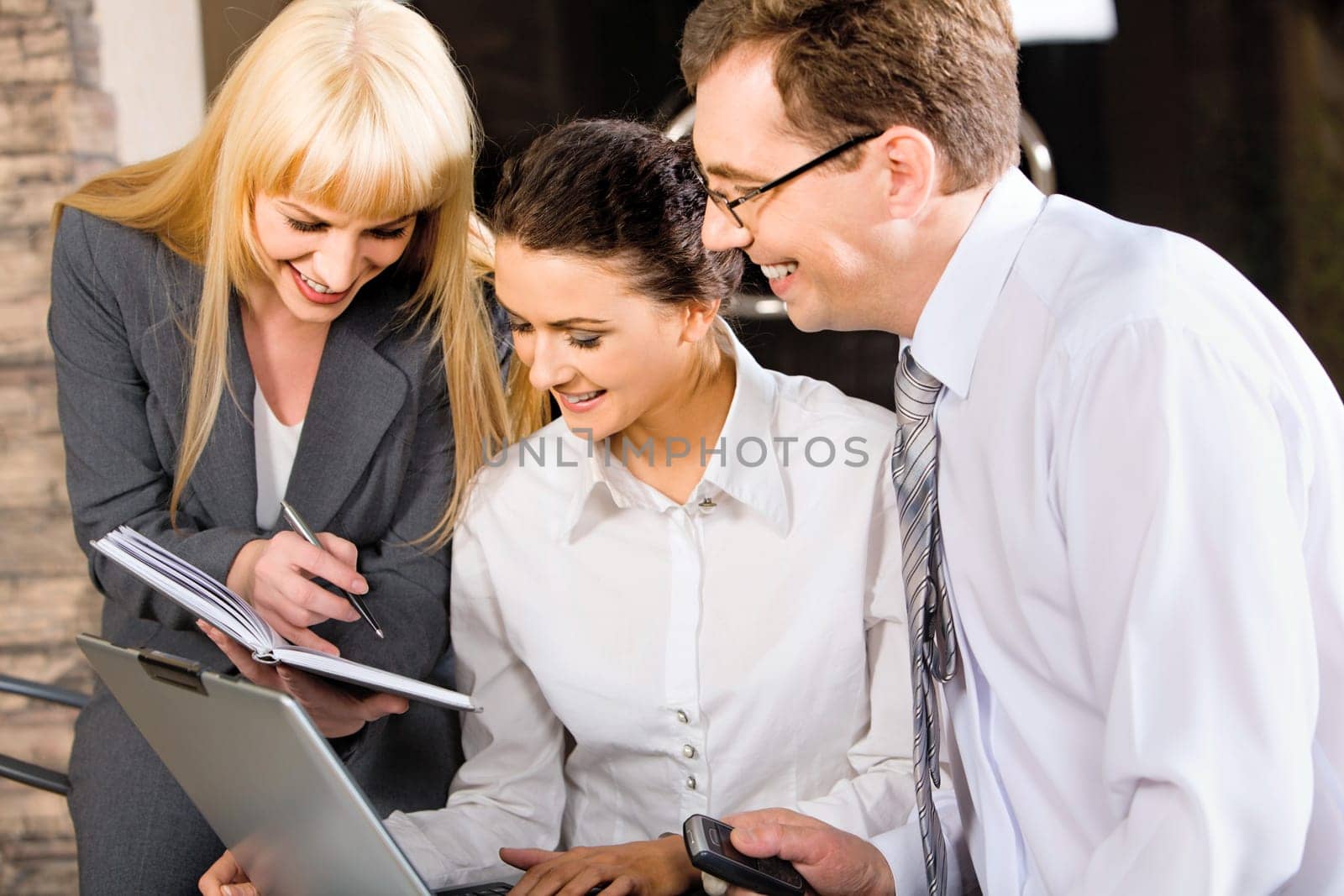 Business team of three professionals discussing a strategy-business