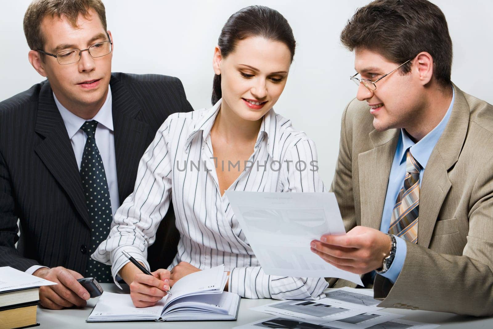 Confident boss is showing research results to his team in the office