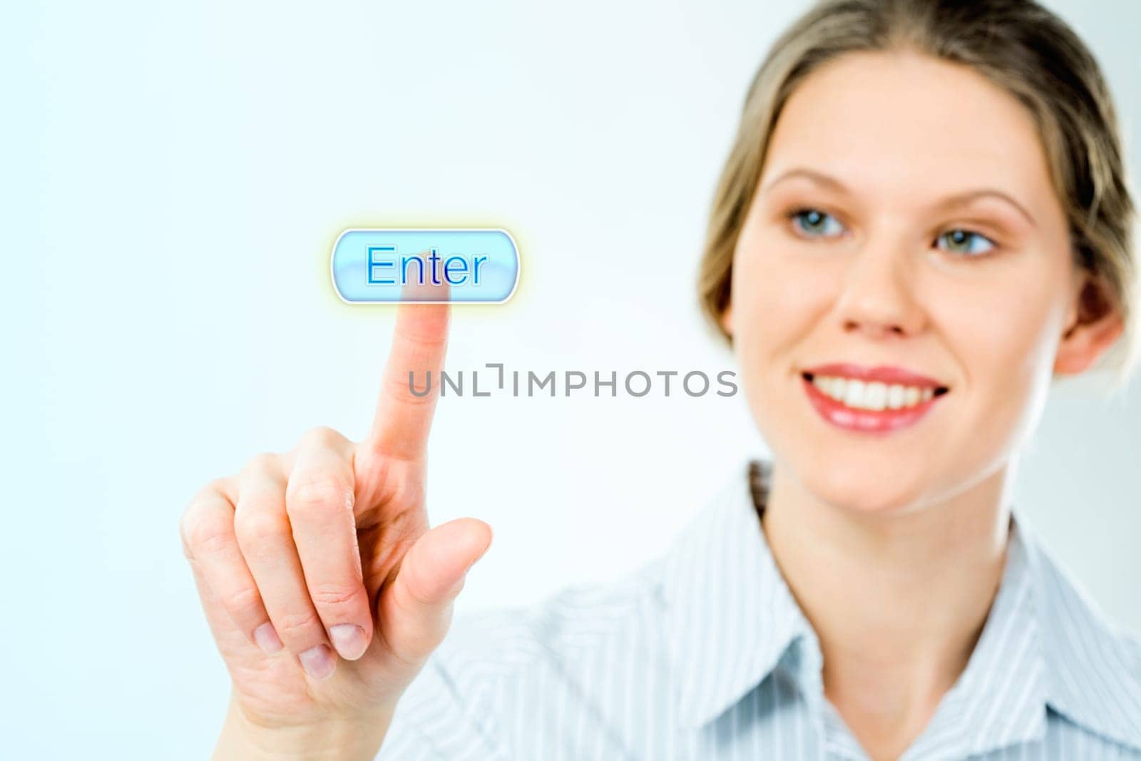 Portrait of businesswoman looking at the enter button and touching it with her forefinger with smile