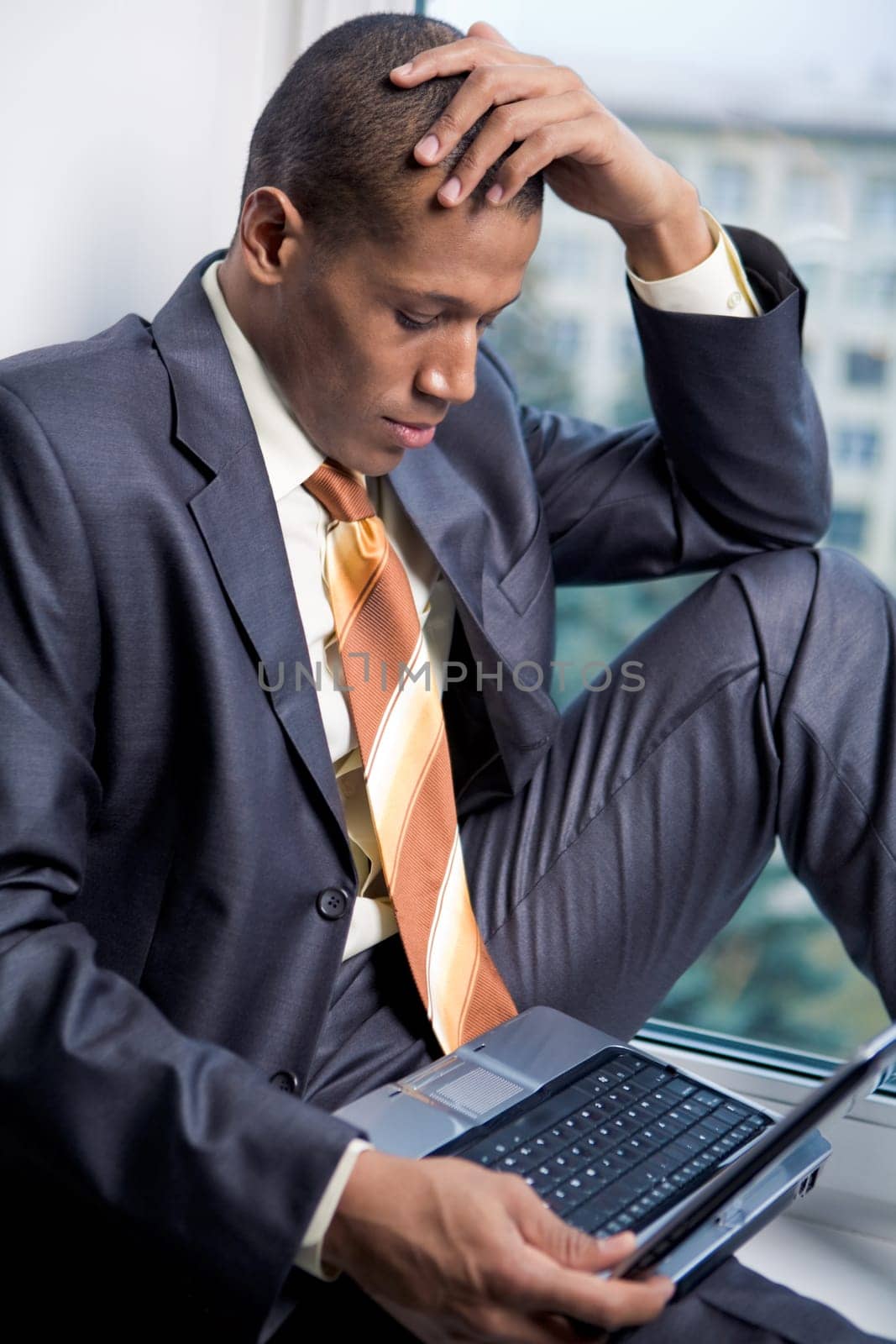 Photo of handsome employee working in office with laptop in front